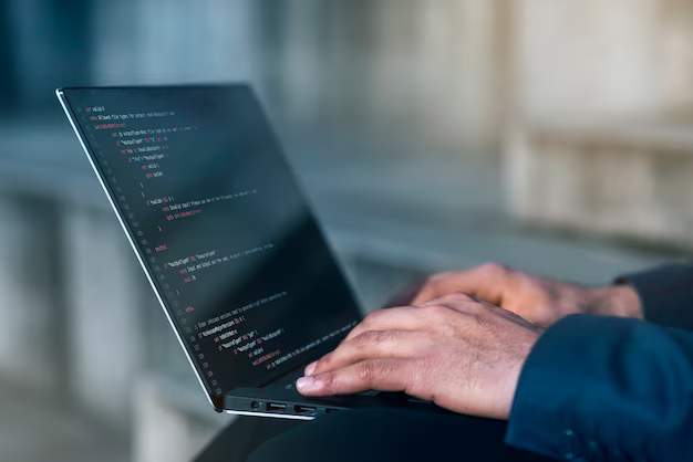 Side view of man working on laptop