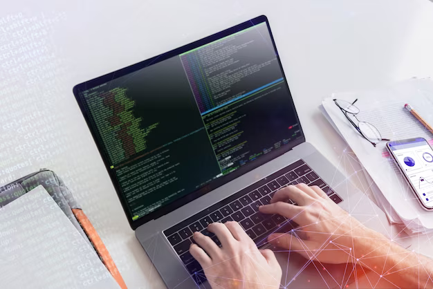 Hands on laptop keyboard writing code