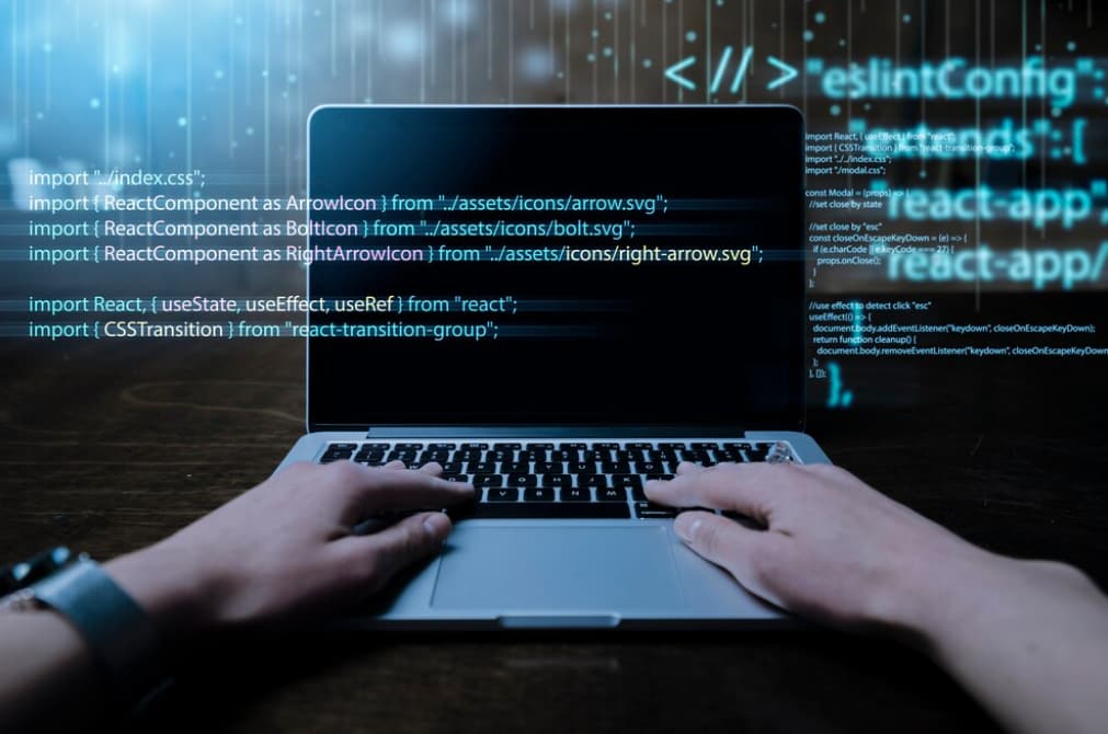 on a laptop with code projected in front