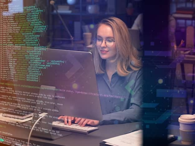 The girl with the glasses is programming on the computer